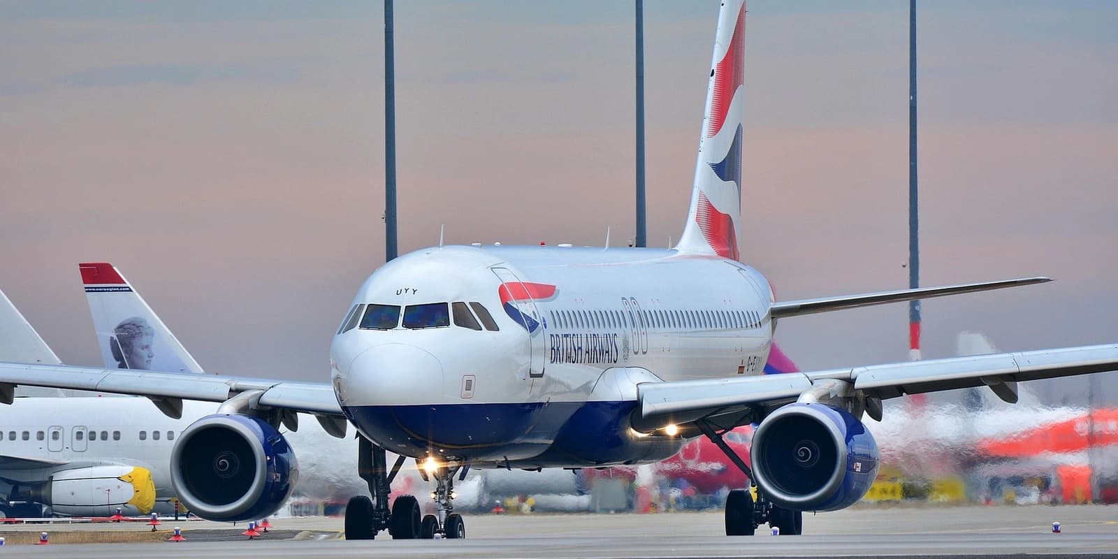 British Airways passenger aircraft on the runway with distinctive red, white and blue tail design.