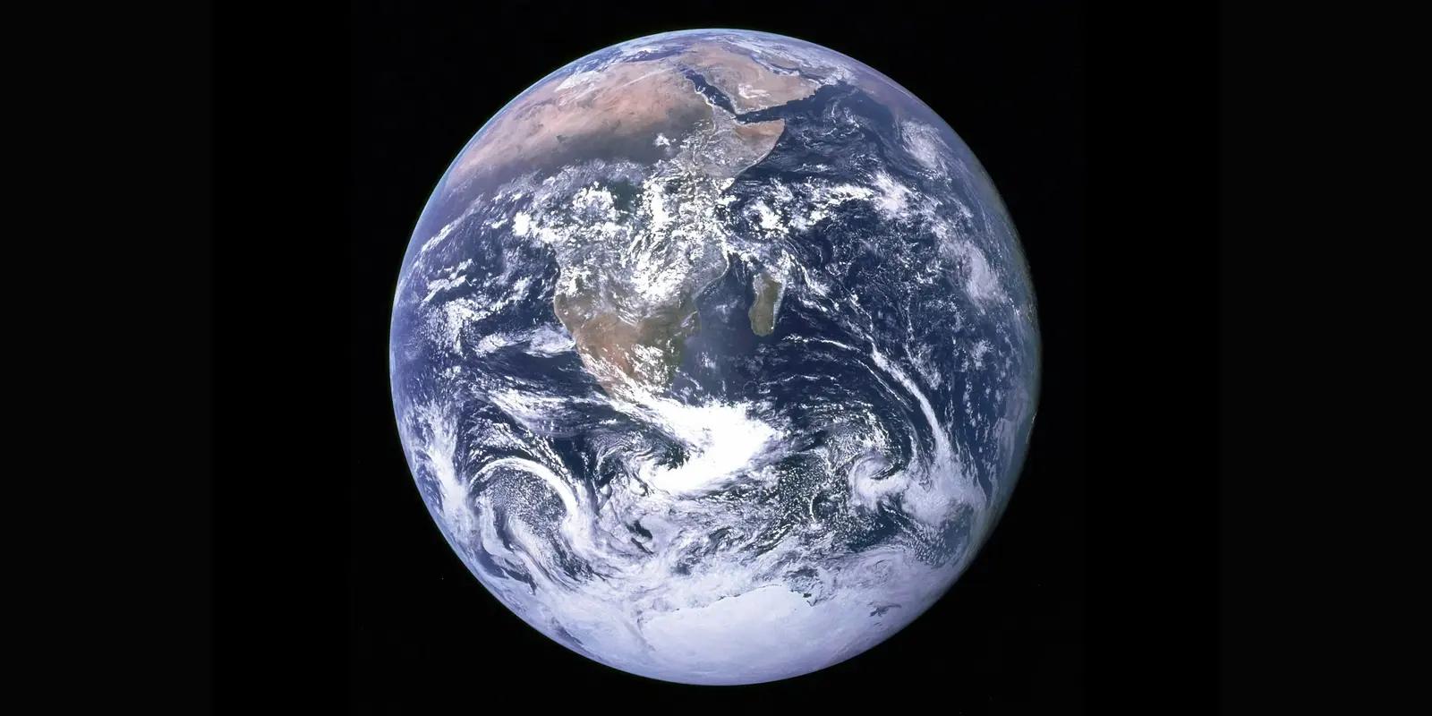 A stunning image of planet Earth as seen from space, showcasing its blue oceans, swirling white clouds, and visible landmasses.