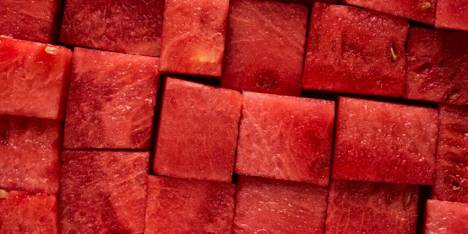 Close-up of freshly cut watermelon cubes, showcasing their vibrant red color, juicy texture, and natural patterns.