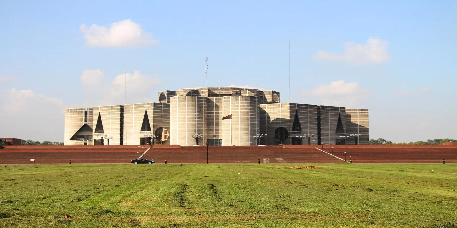 The Jatiya Sangsad Bhaban (National Parliament House) in Dhaka, Bangladesh, featuring its unique modernist architecture with geometric shapes and concrete surfaces.