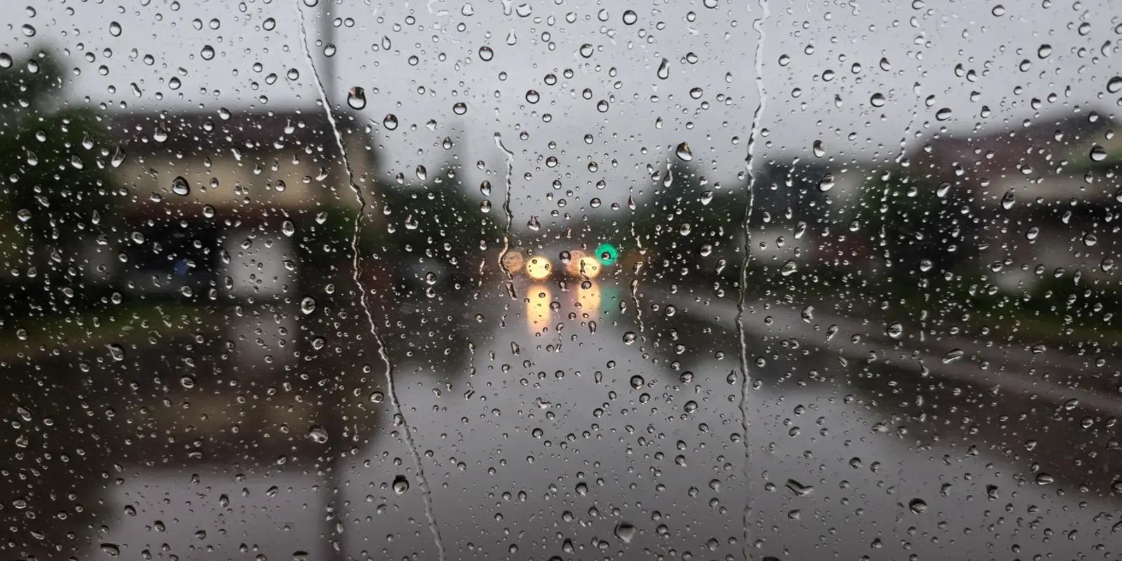 Rainy street view through a wet window.