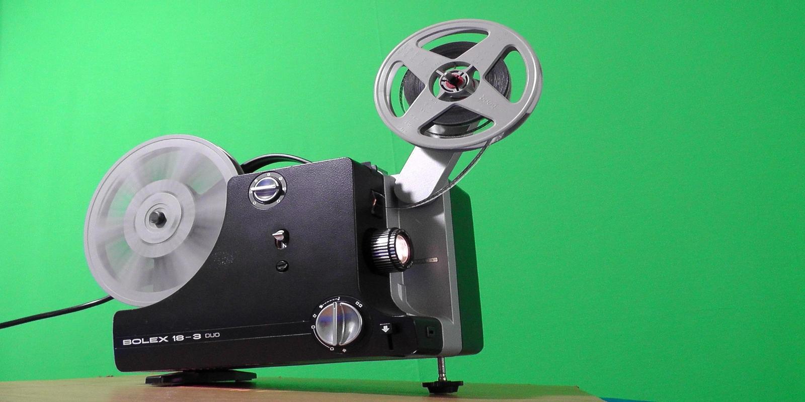 A Bolex 18-5 Super 8 film projector with two reels of film.